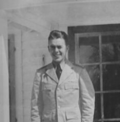 A black and white photo of a smiling man