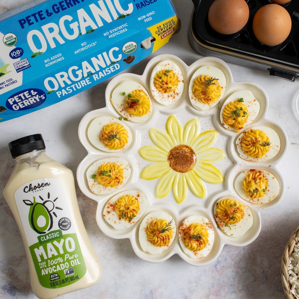 Deviled eggs on a flower-shaped platter next to a mayo bottle.