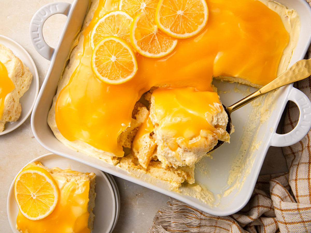 A citrusy recipe for homemade lemon tiramisu featuring creamy lemon curd, fluffy mascarpone filling, and lemon slices for garnish. | peteandgerrys.com