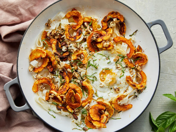 Roasted Delicata Squash Pasta With Fried Egg, Goat Cheese, and Hazelnuts
